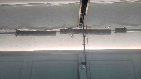 Picture of 2 broken torsion garage door springs