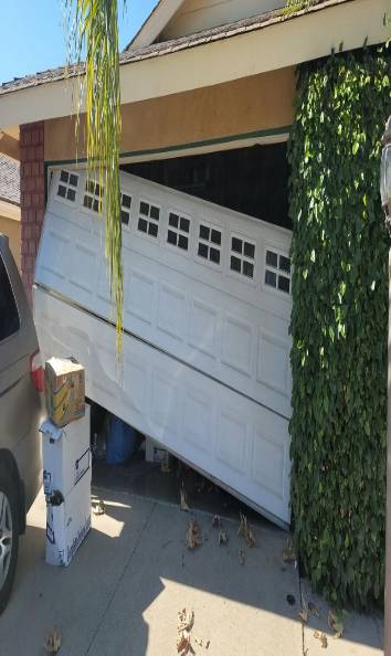 Broken-garage-door-with-cable-off