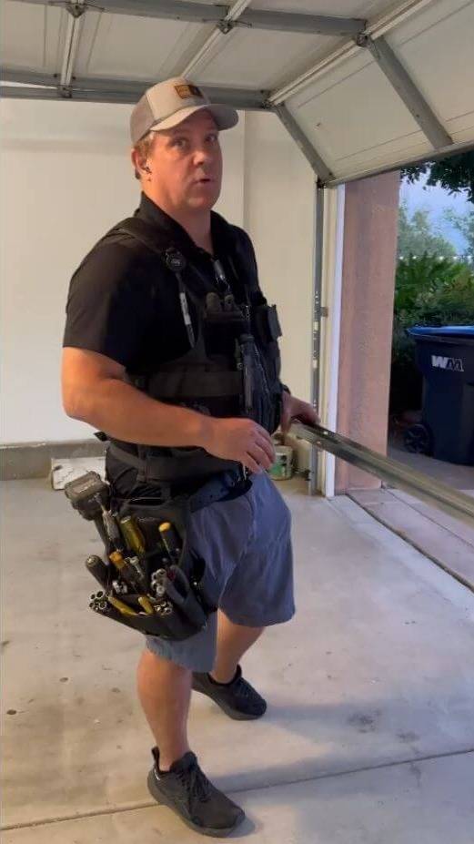 Technician performing garage door repair