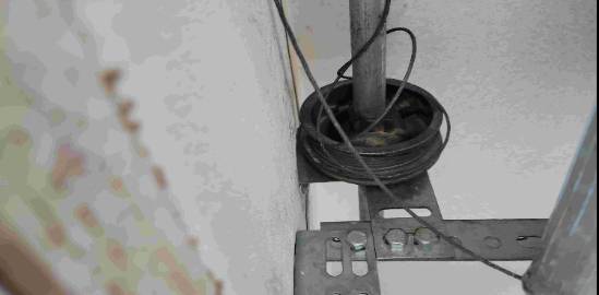 vintage garage maintenance, nostalgic look, oiling door tracks, photorealistic, small-town setting with picket fences, highly detailed, light rain drizzle, 50mm f/1.8 lens, sepia tones, soft afternoon lighting, shot with a Fujifilm XF 35mm f/2 R WR lens.