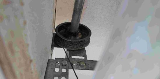 rustic door repair, concentrated expression, sanding door edges, photorealistic, mountain cabin with forest, highly detailed, birds chirping, 85mm f/1.4 lens, earthy greens and browns, dappled sunlight, shot with a Canon EF 85mm f/1.2L II USM lens.